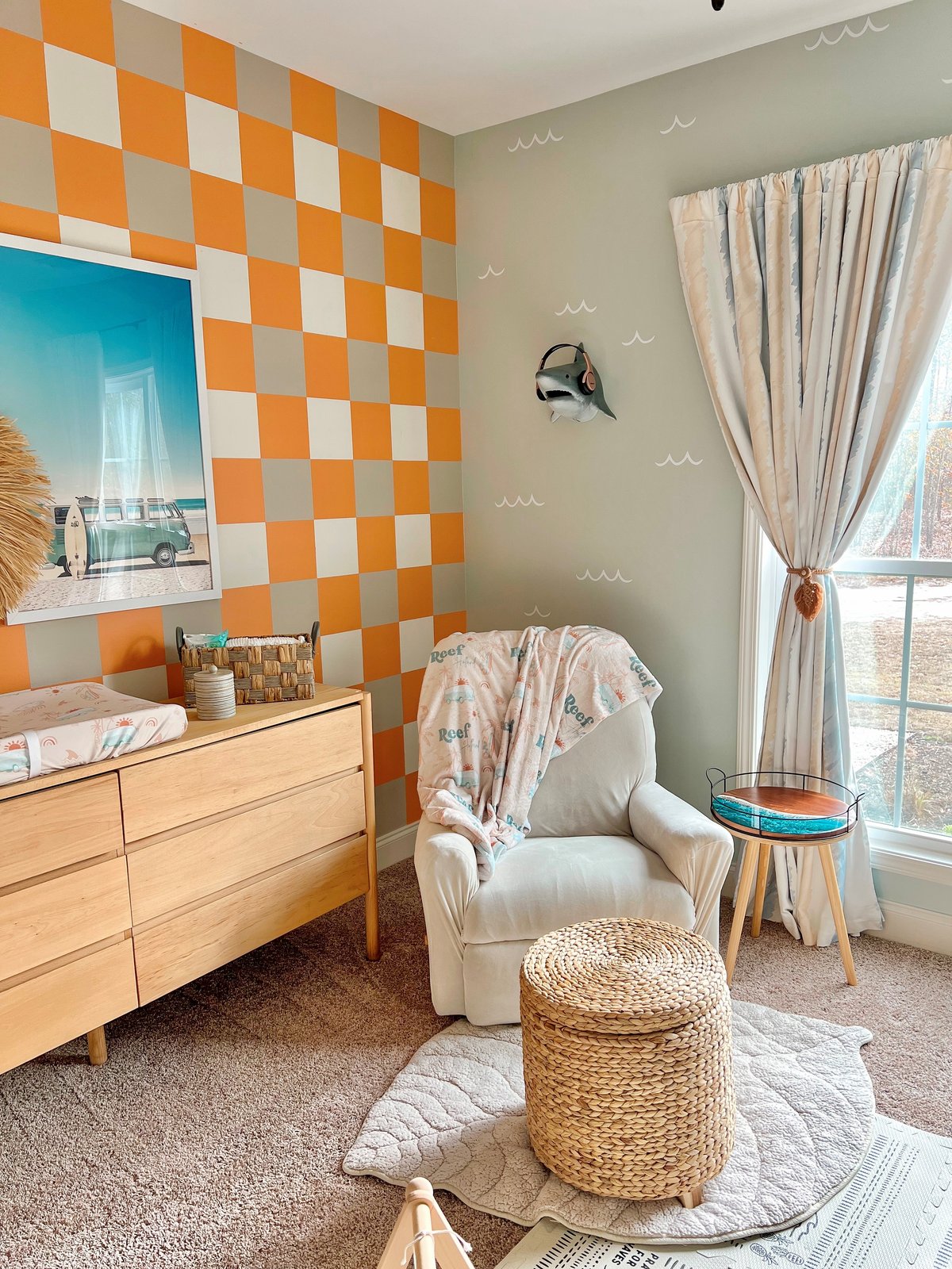 Reef room with hand-painted checkerboard wall, shark head, wave details, and boho surfer decor